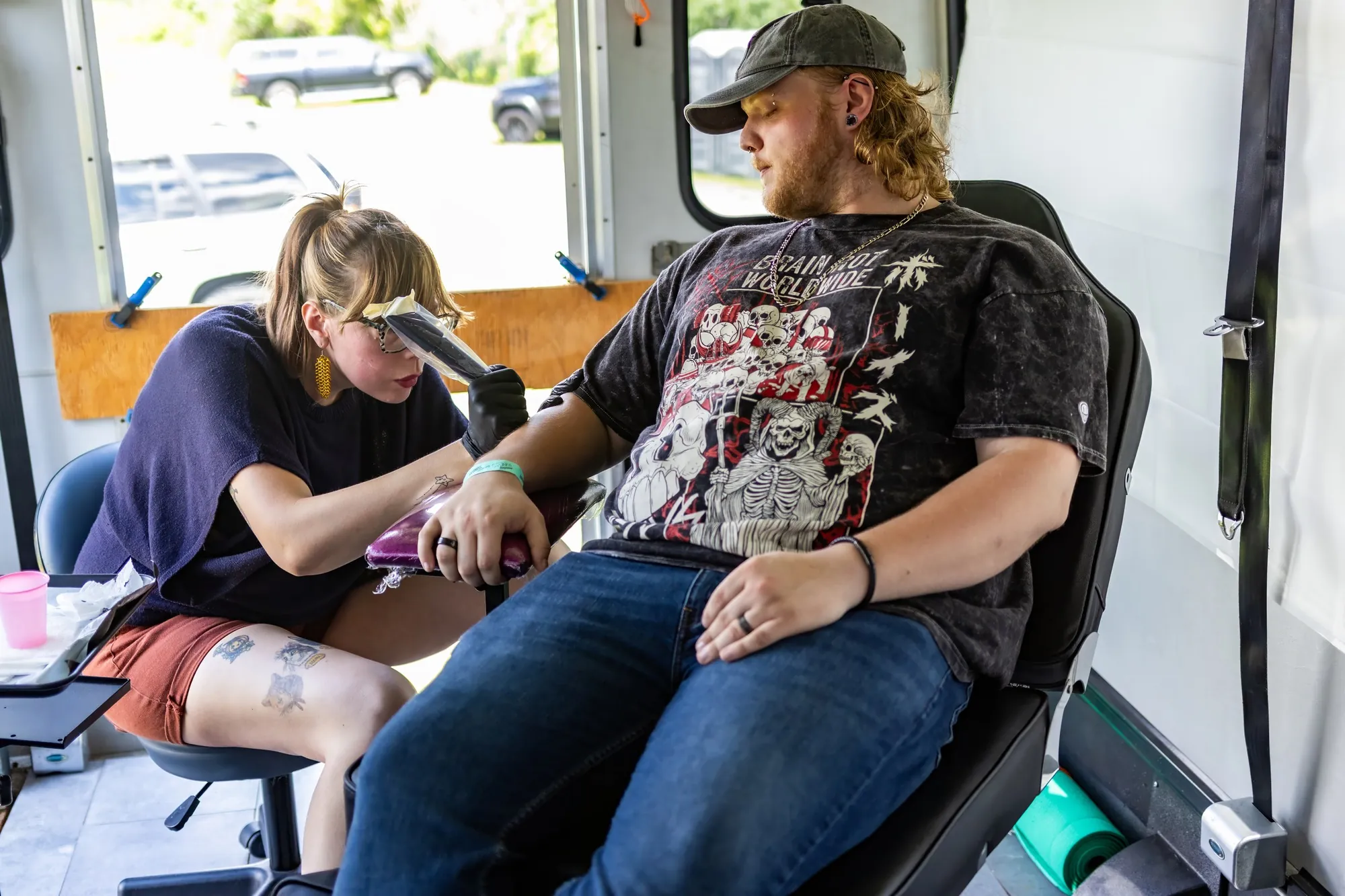 A tattoo artist at work in the Backstage Village